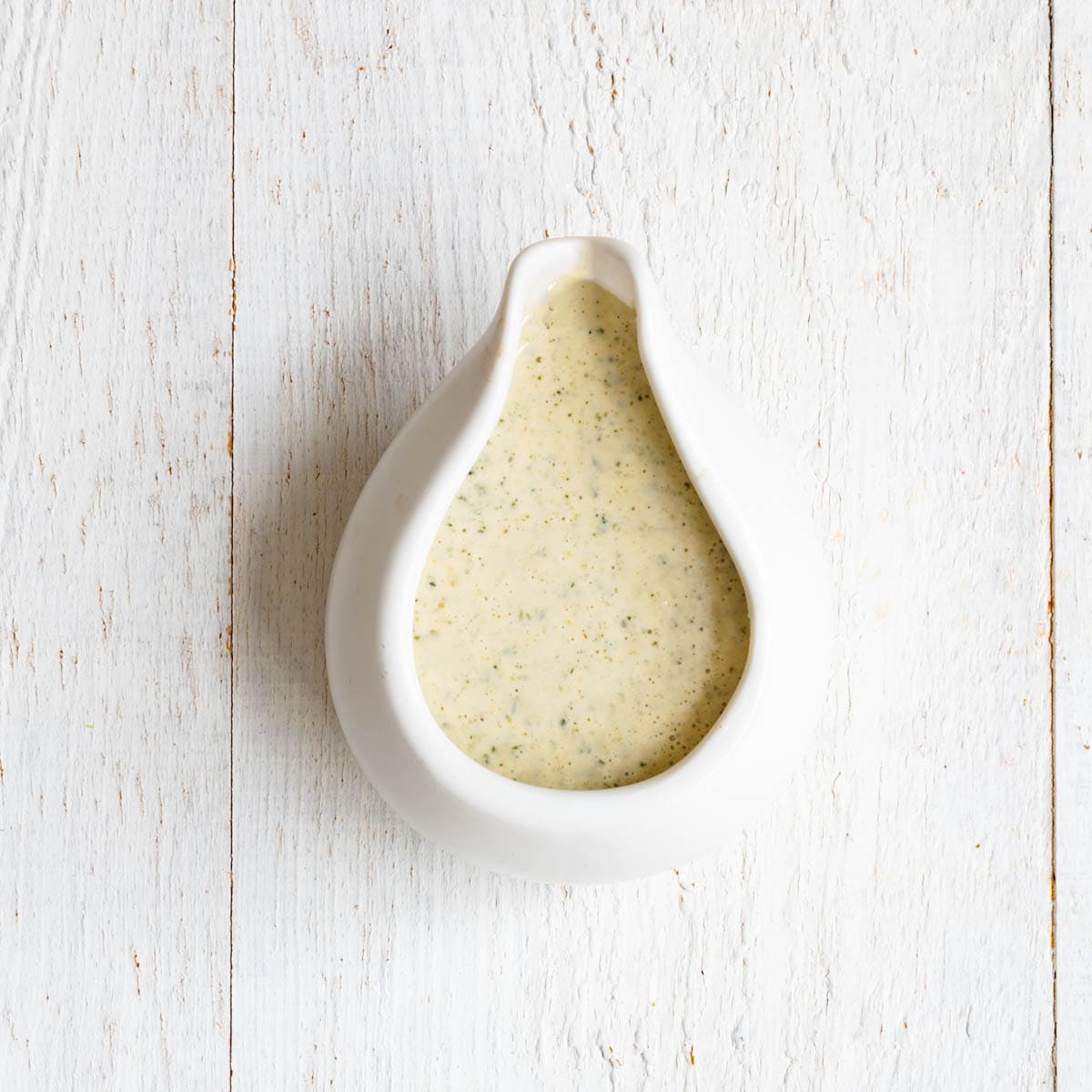 Hemp cream in a white pouring bowl.