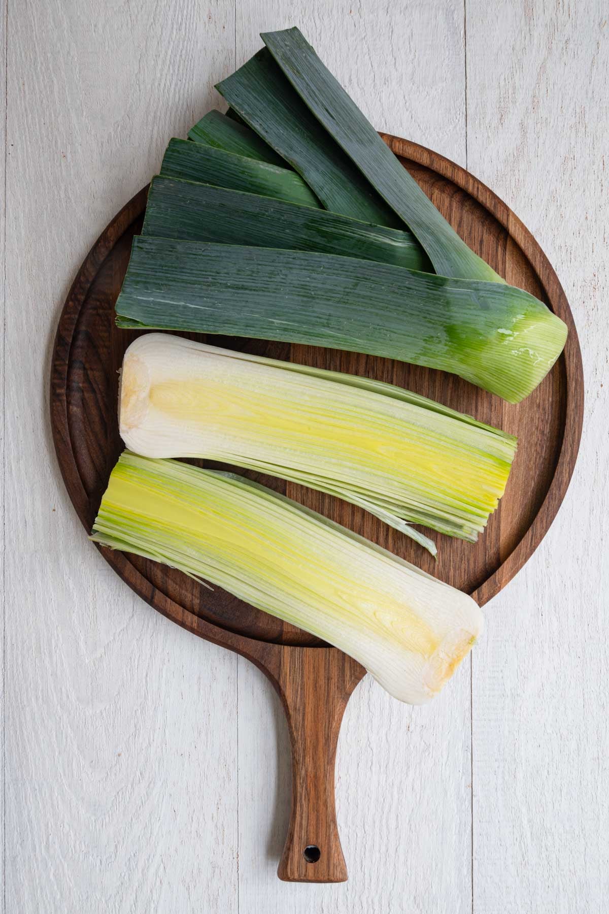 How to cut leek showing one leek cut in half.