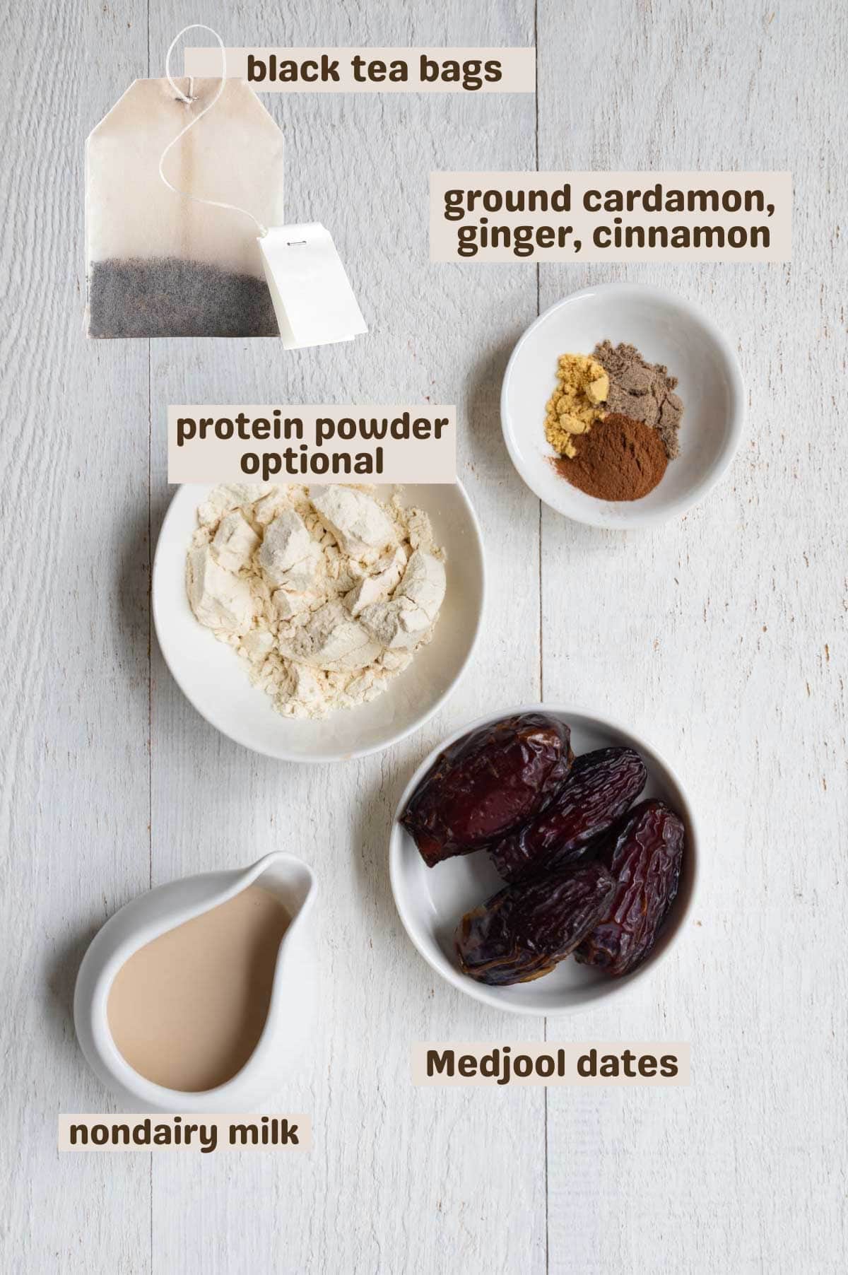 Black tea bags, ground cardamom, ginger, cinnamon, protein powder, nondairy milk, and dates.