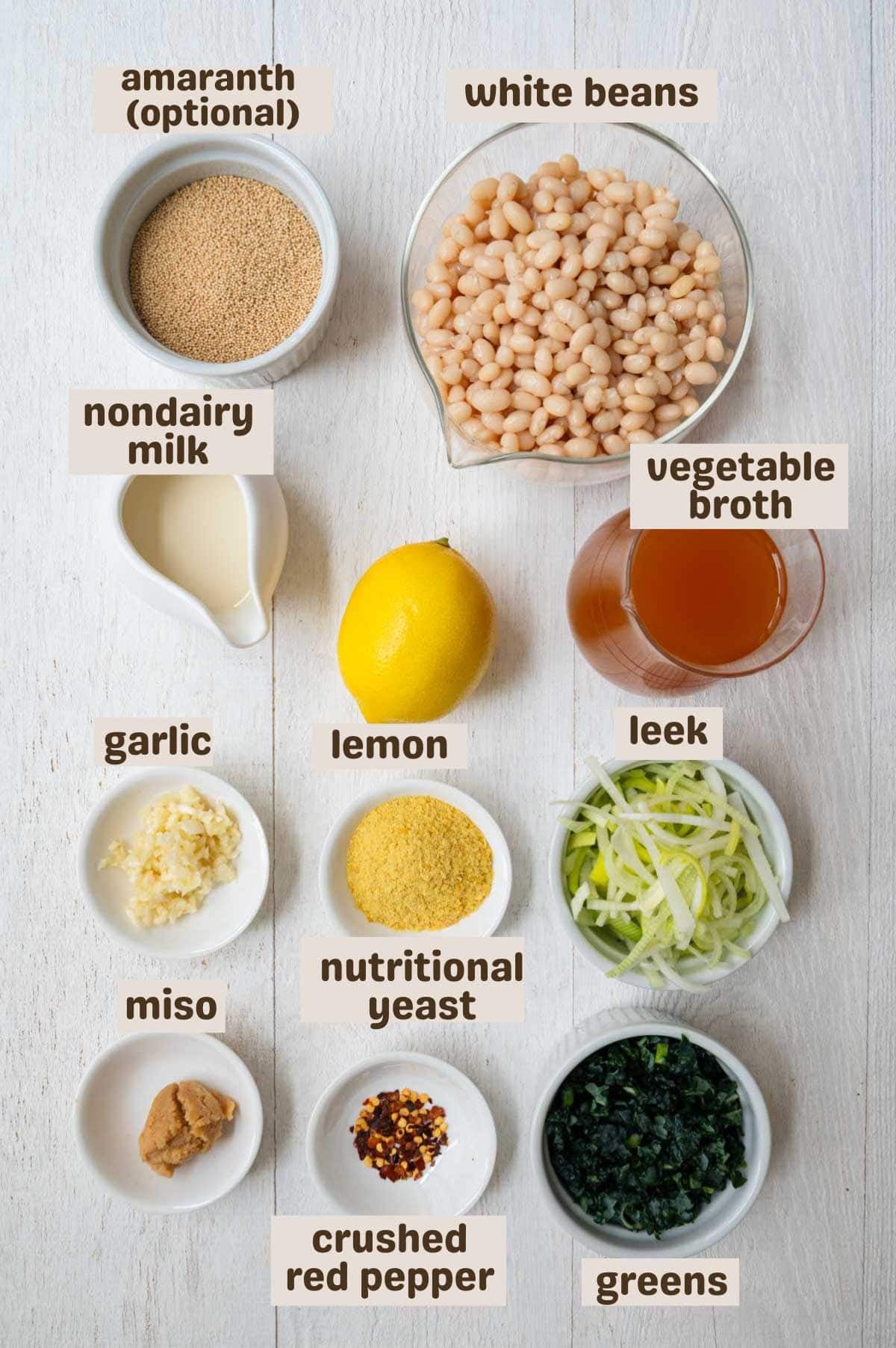 White beans, amaranth, chopped leek, vegetable broth, nondairy milk, nutritional yeast, chopped kale, crushed red pepper, miso, minced garlic, and lemon.