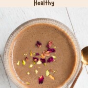 Easy protein chai latte naturally sweetened with dates topped with rose petals and chopped pistachios.