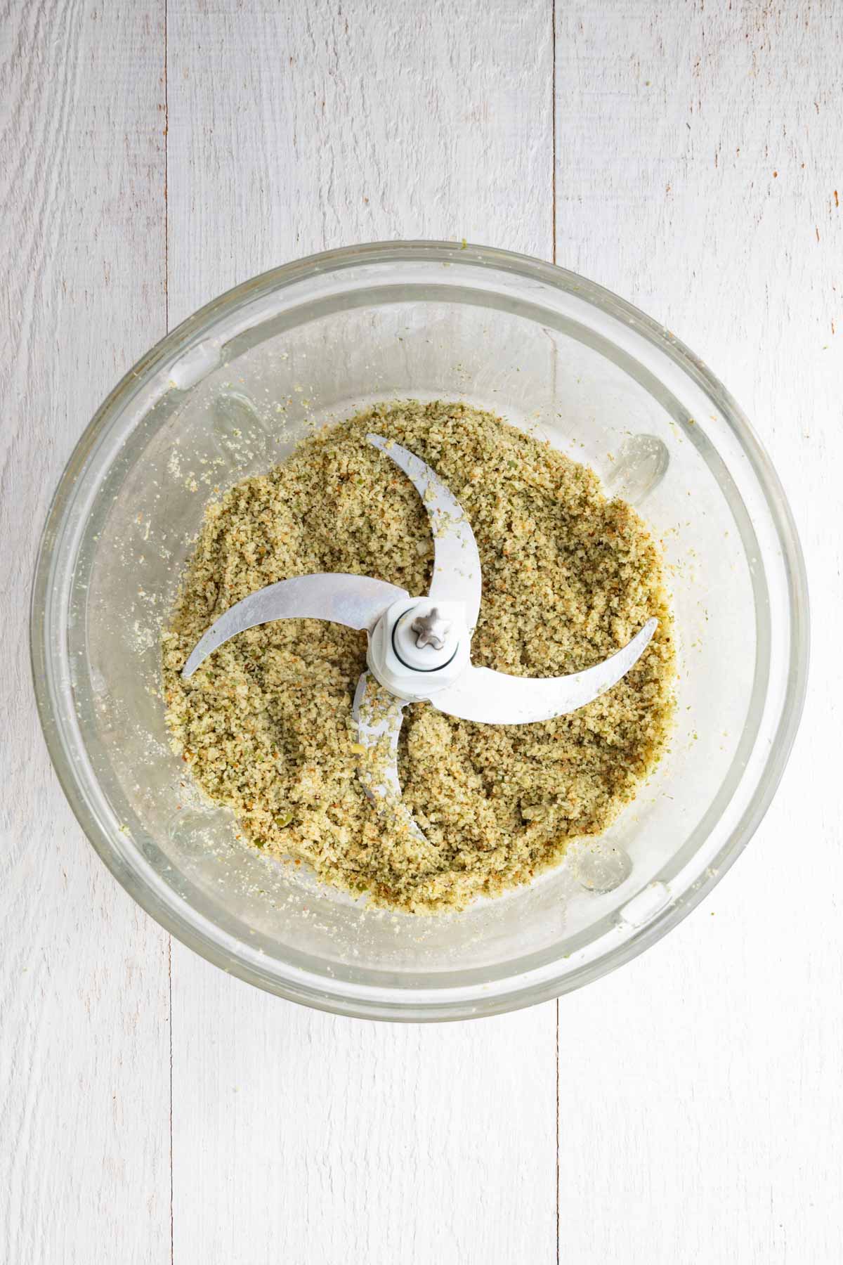 Ground pumpkin seeds and walnuts in a food processor.