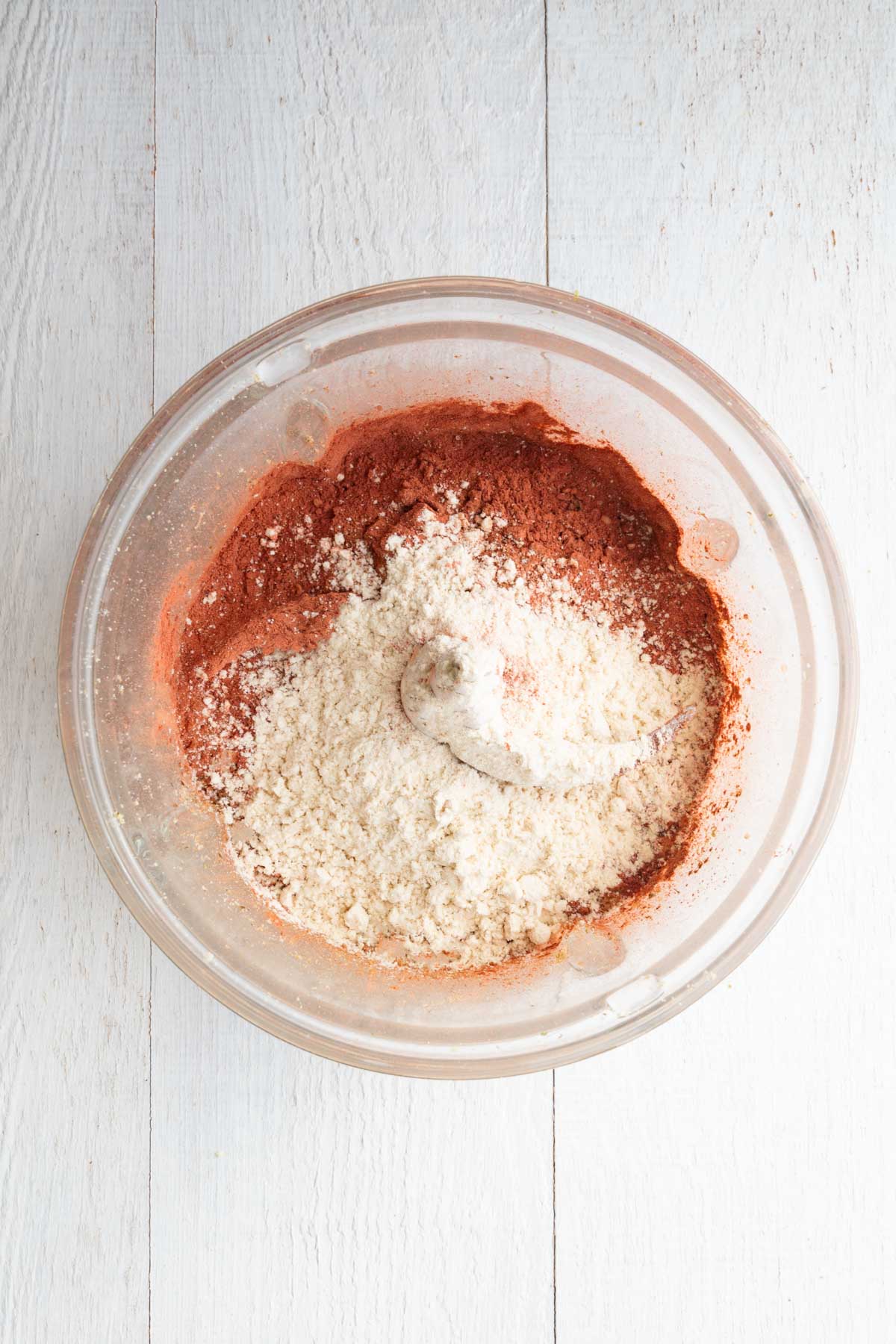 Processed walnuts, pumpkin seeds, protein powder, hemp hearts, beet powder and cinnamon in a food processor.