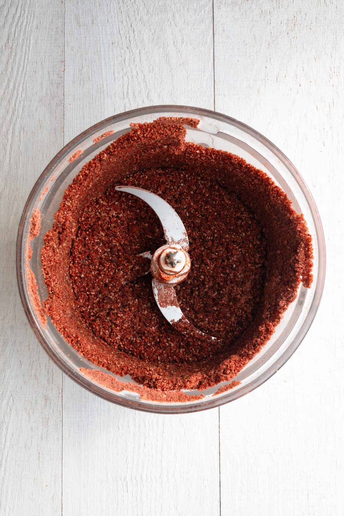 Crumbly nut, seed, and date batter in a food processor.