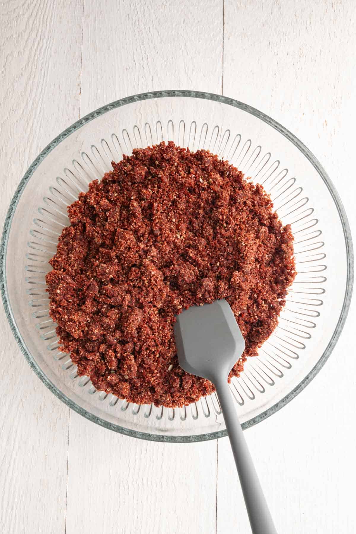 Crumbly batter in a glass bowl.