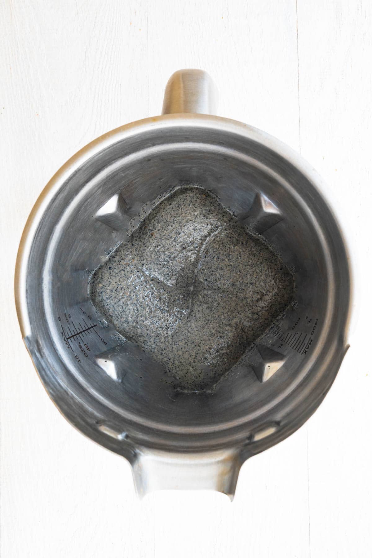 Creamy black paste in blender of ground black sesame seeds blended with cooked lentils, soaked dates, and nondairy milk.