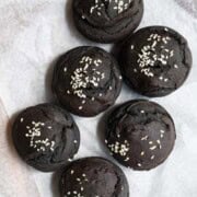 Black sesame date cupcakes on a cutting board.