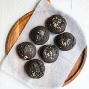 Black sesame date cupcakes on a cutting board.