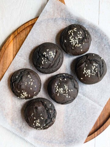 Black sesame date cupcakes on a cutting board.