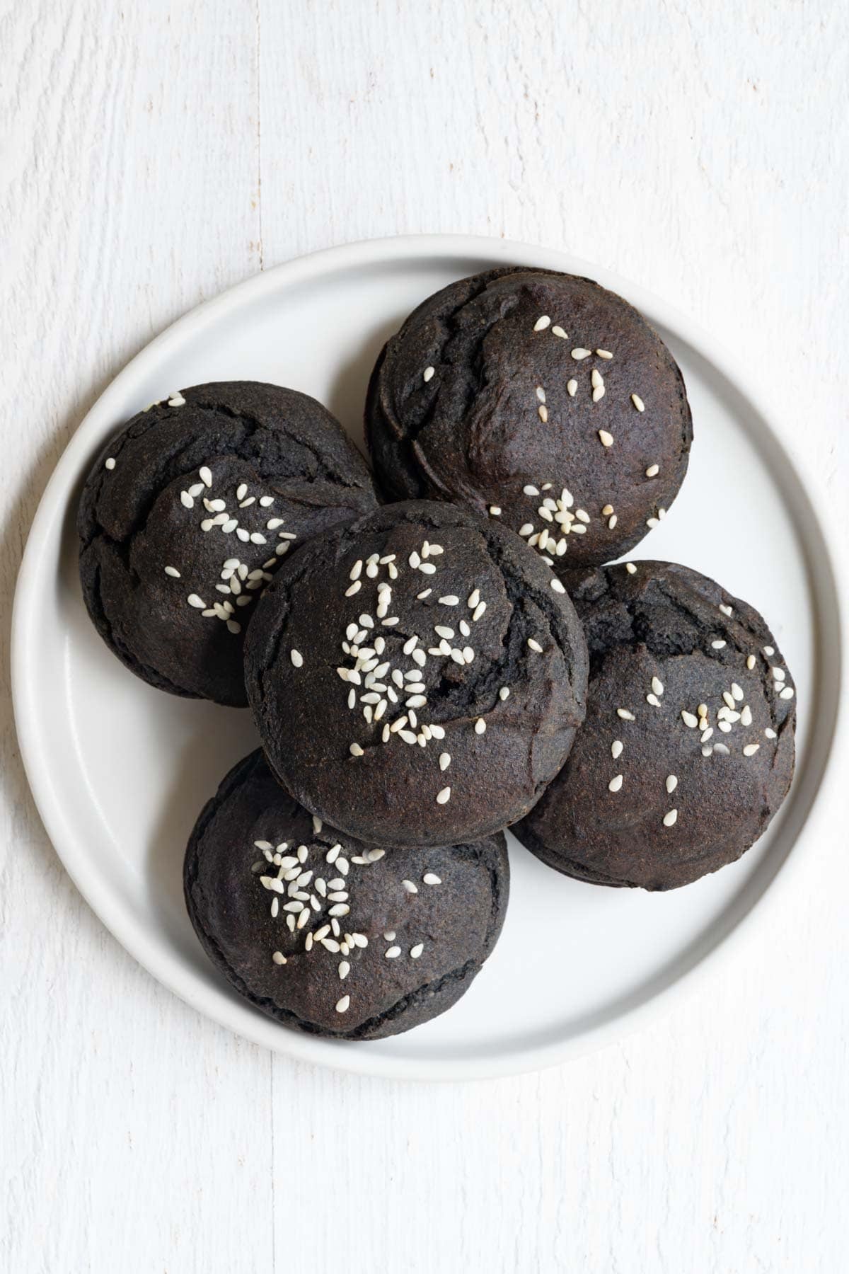 Black sesame date cupcakes on a white plate.