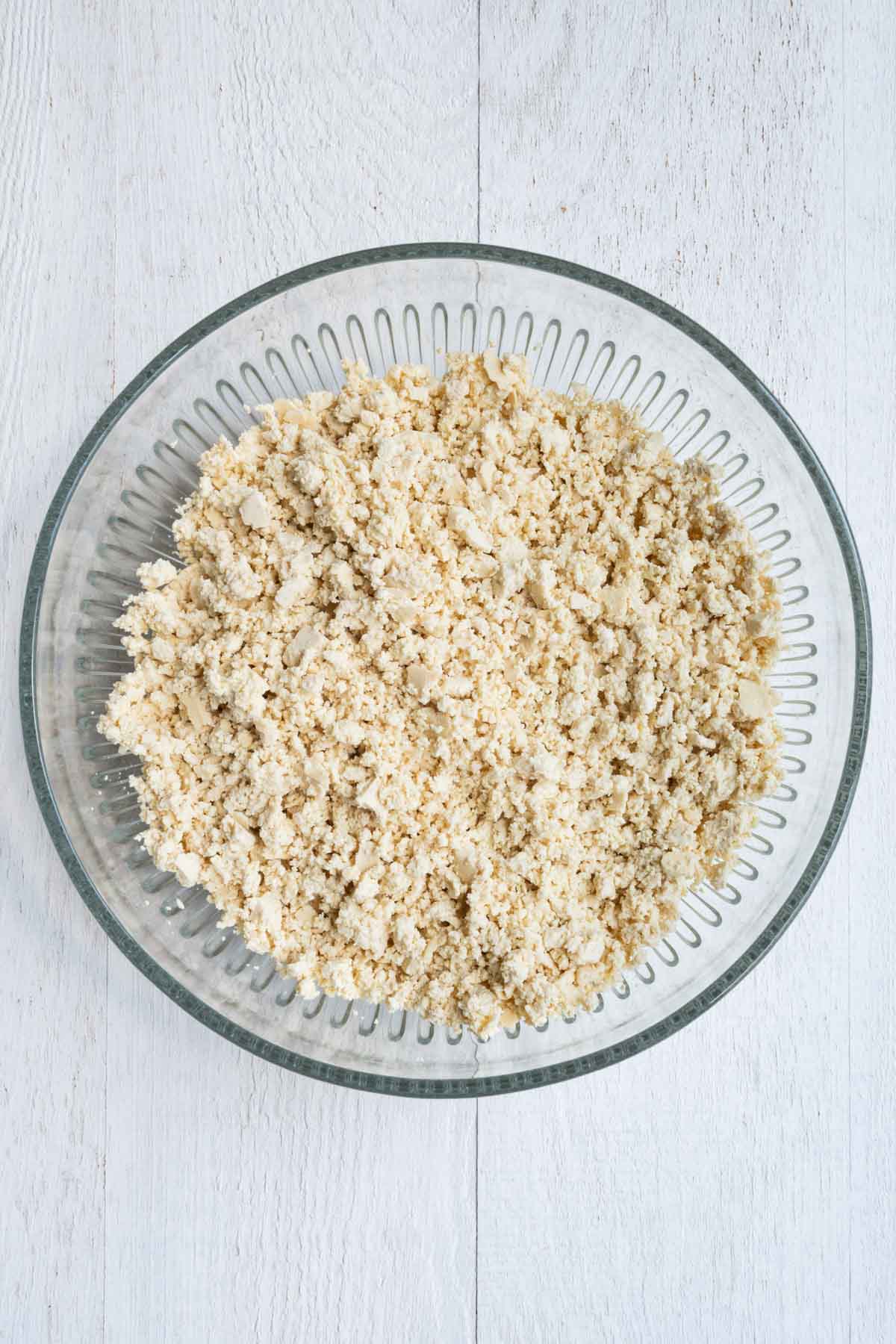 Crumbed tofu in a glass bowl.