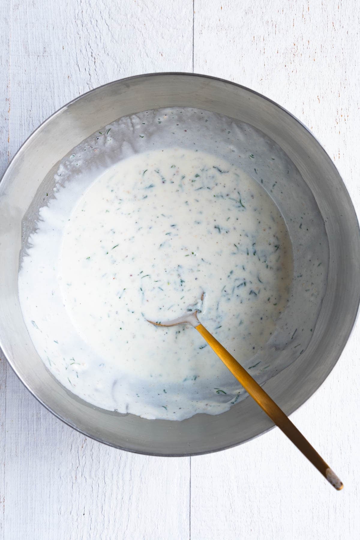 Greek yogurt salad dressing in a mixing bowl.
