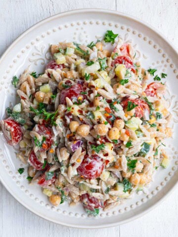Greek Orzo Pasta Salad on a white plate.