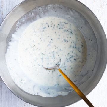 Greek yogurt salad dressing in a mixing bowl.
