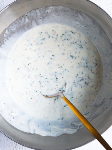 Greek yogurt salad dressing in a mixing bowl.
