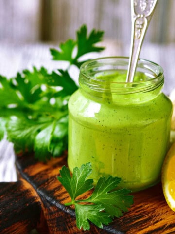 Herb Greek yogurt sauce in a glass jar.