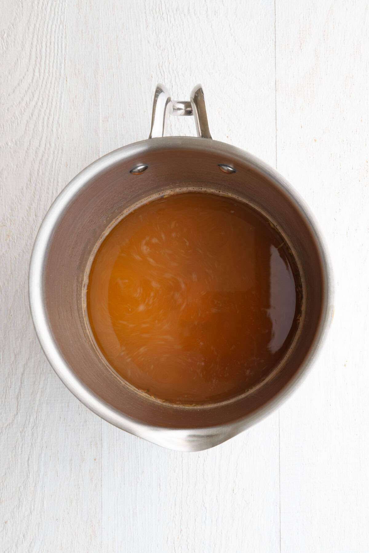 Homemade ramen broth in a saucepan.