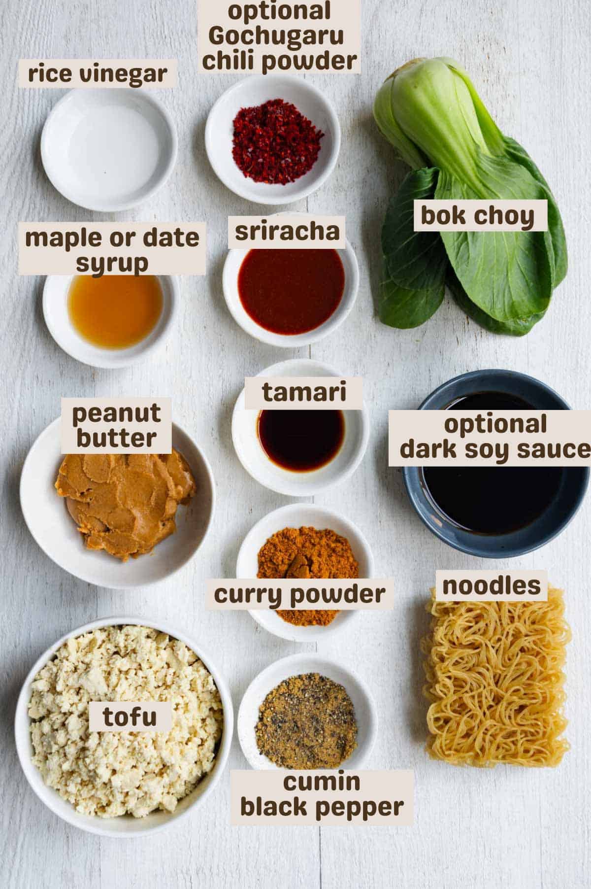 Peanut butter, Gochugaru, tamari, rice vinegar, maple syrup, cumin, curry powder, tofu, noodles, sriracha, bok choy, and black pepper.