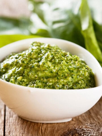 Creamy pumpkin seed pesto in a white bowl.