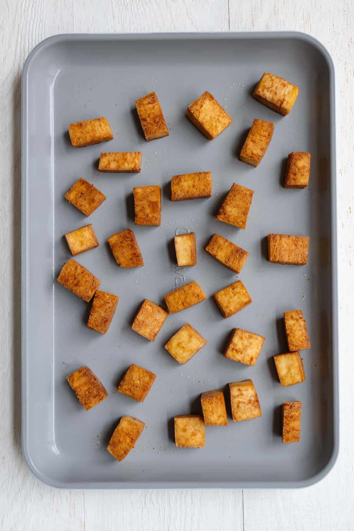 Baked tofu on a baking sheet.