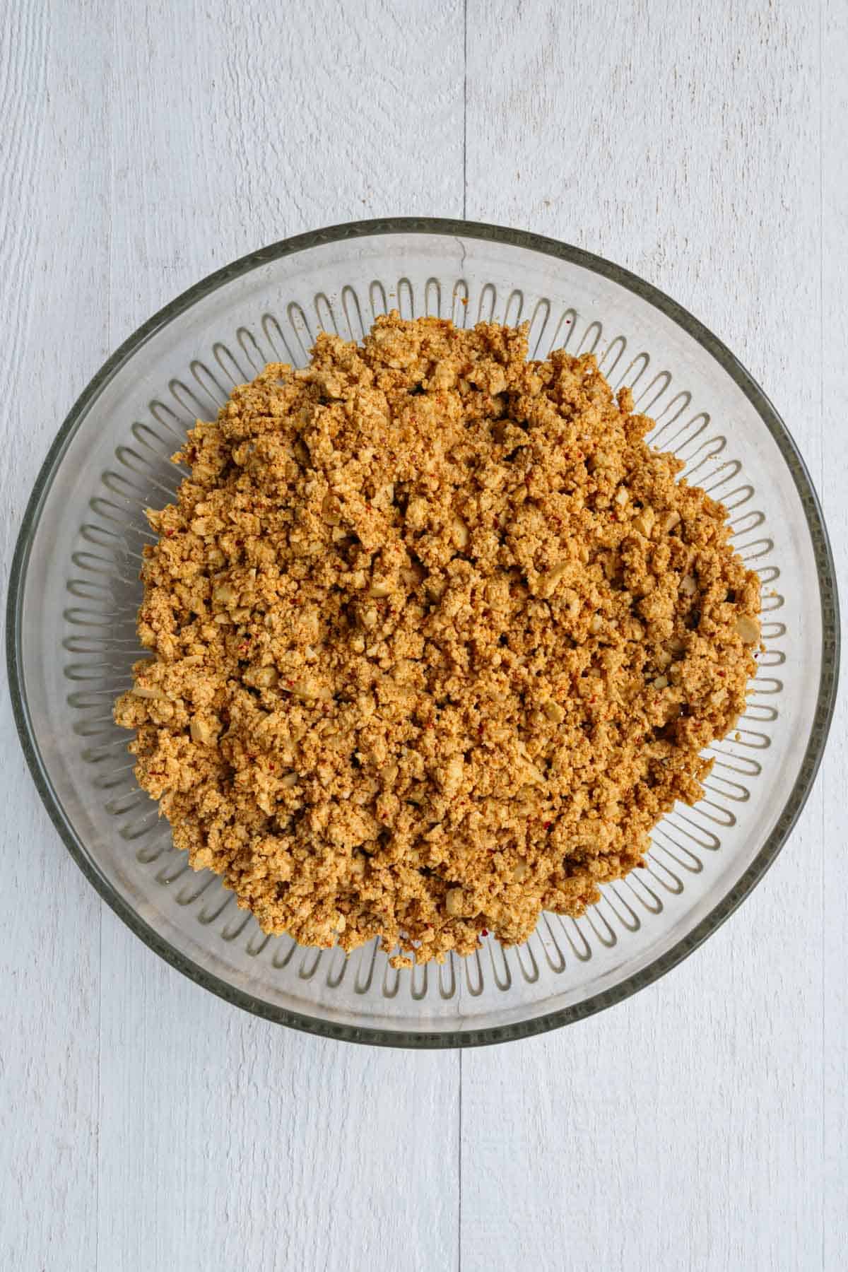 Seasoned crumbled tofu in a glass bowl.