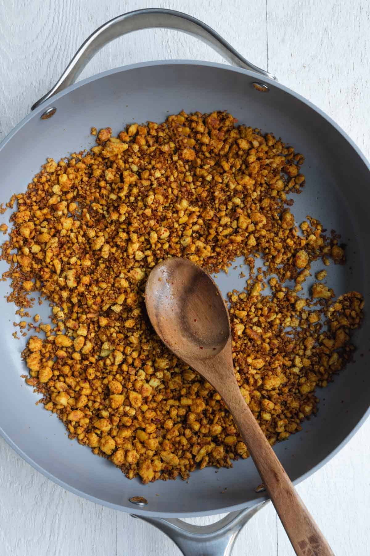 Seasoned crumbled tofu cooked in a large saucepan.
