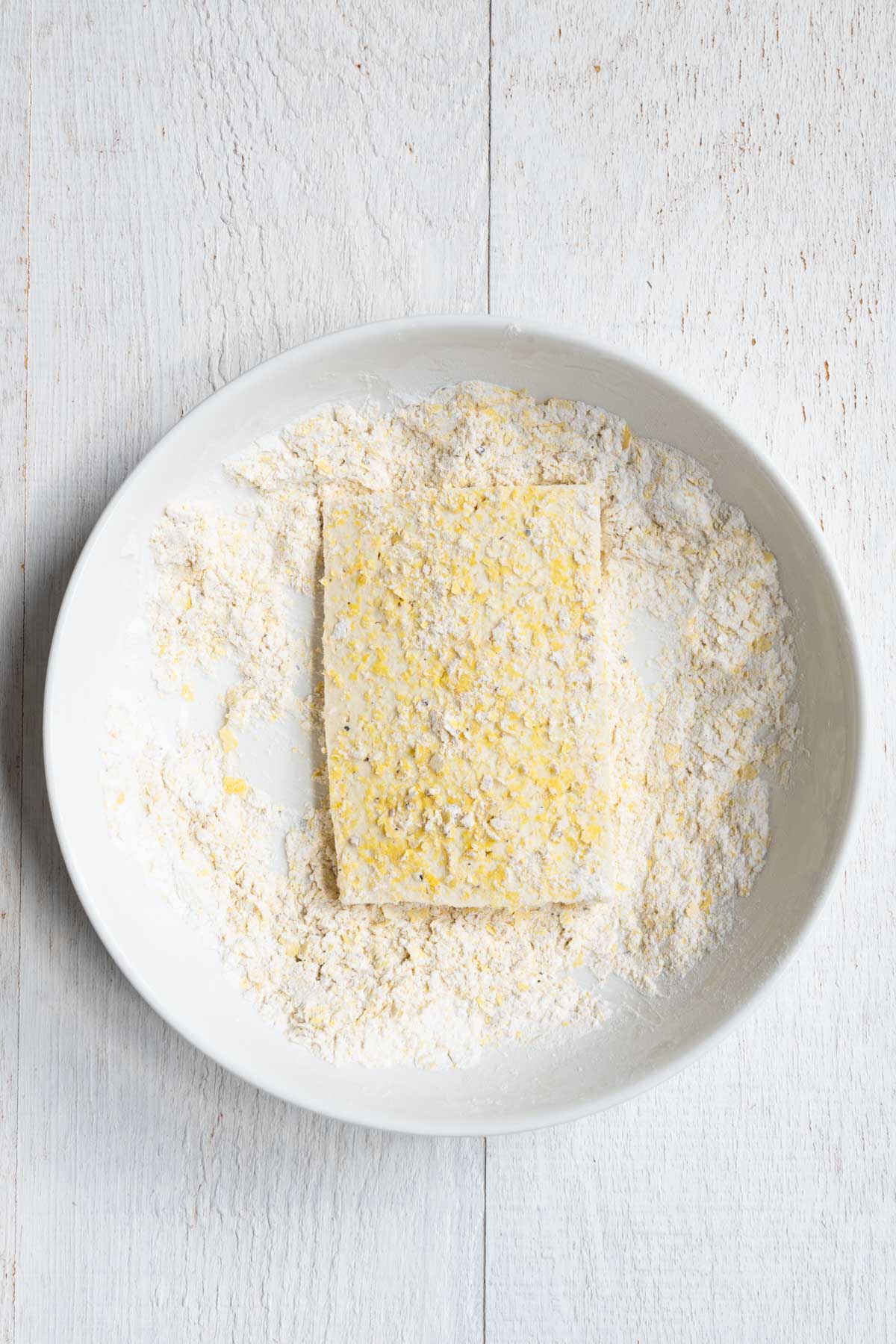 Sliced tofu coated in cornstarch, nutritional yeast, garlic and onion powder, salt, and black pepper.