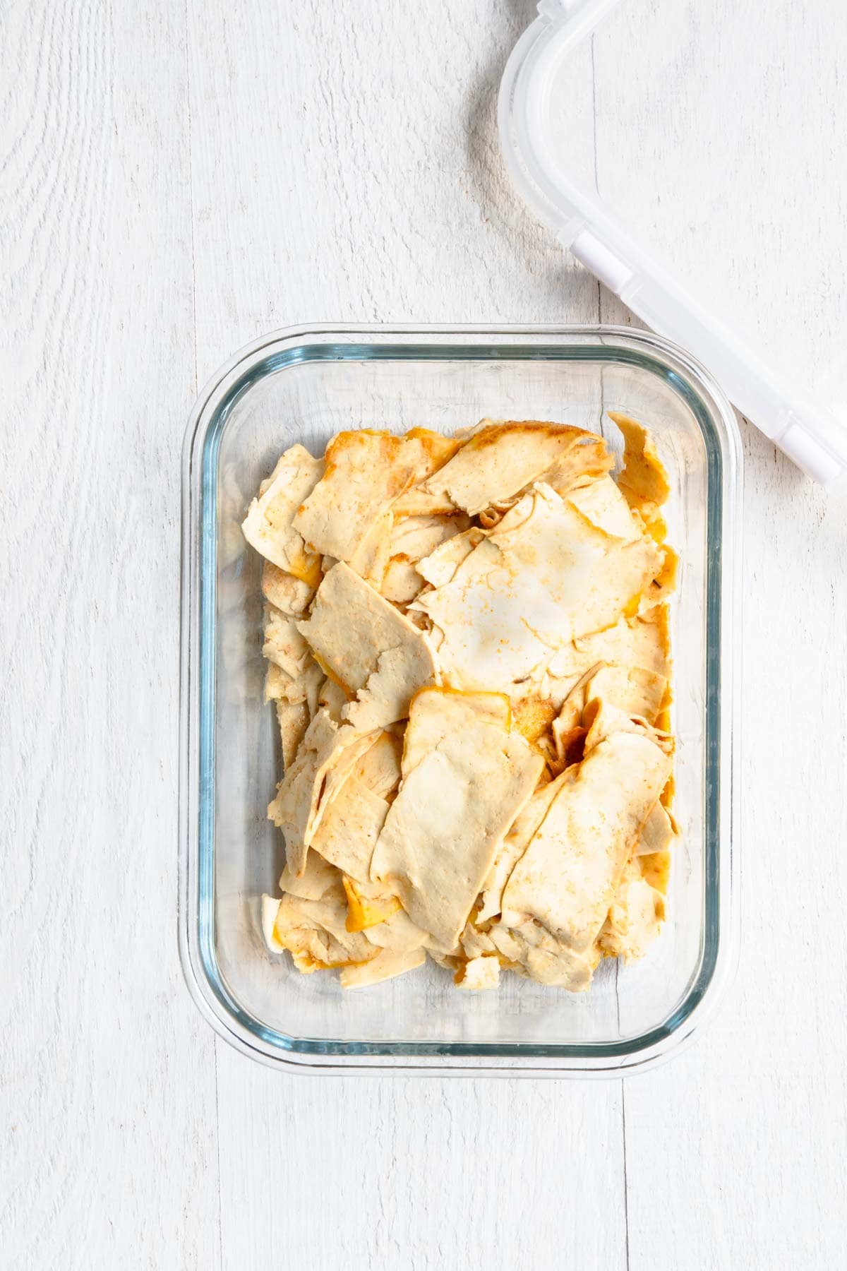 Vegan deli meat in a glass meal prep container.