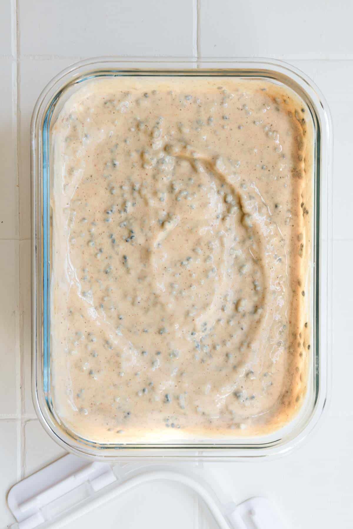 Chia seeds mixed with yogurt, blended banana, and nondairy milk in a glass container.