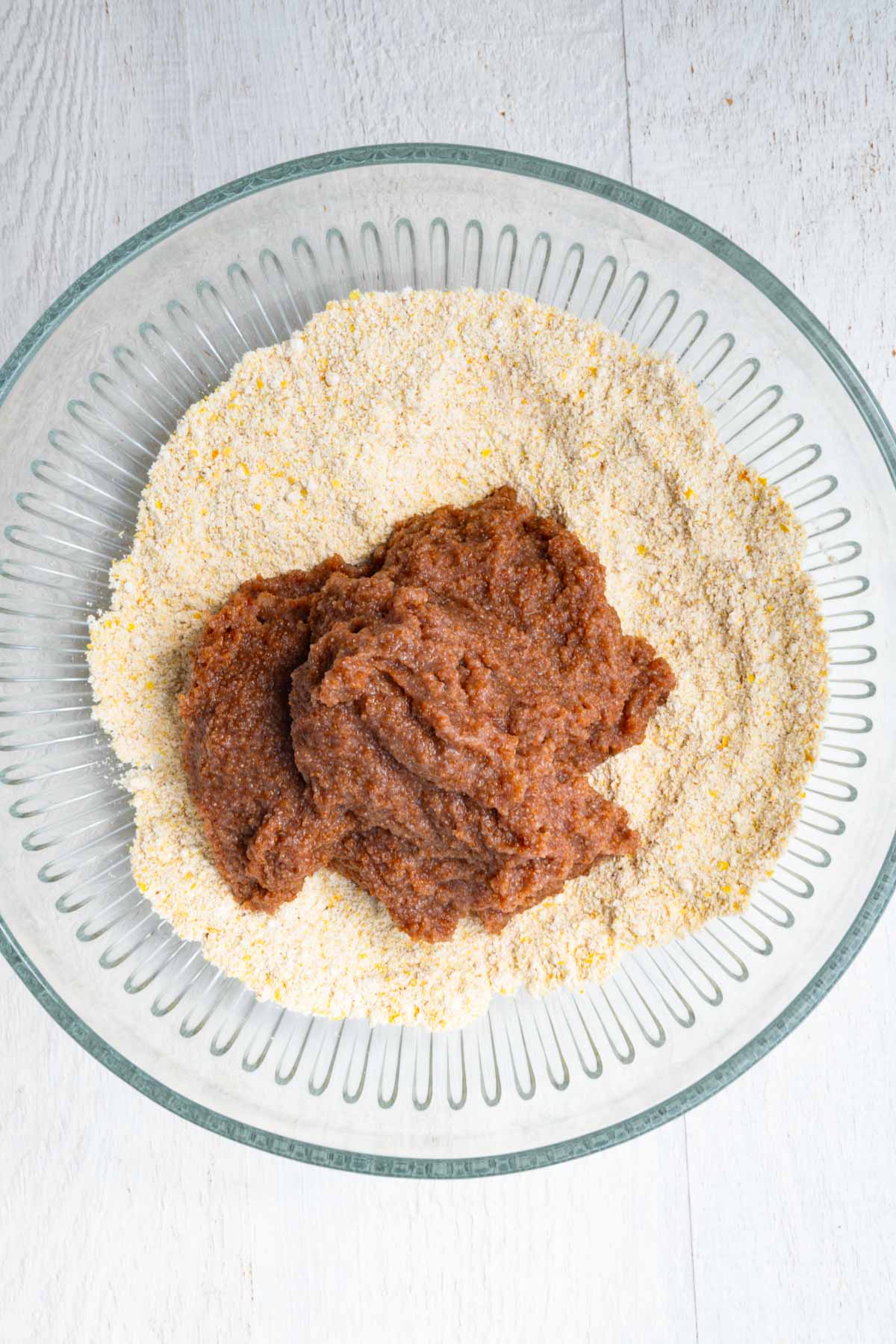 Blended teff and water with dry bread ingredients in a bowl.