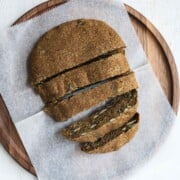 Gluten free teff bread sliced on a cutting board.