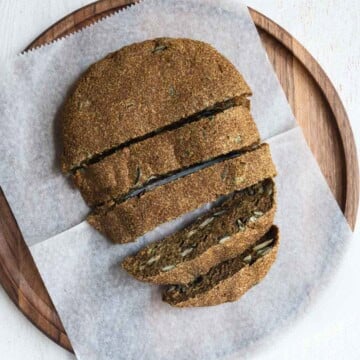 Gluten free teff bread sliced on a cutting board.
