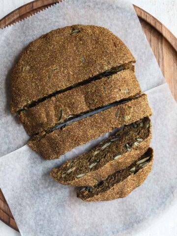 Gluten free teff bread sliced on a cutting board.