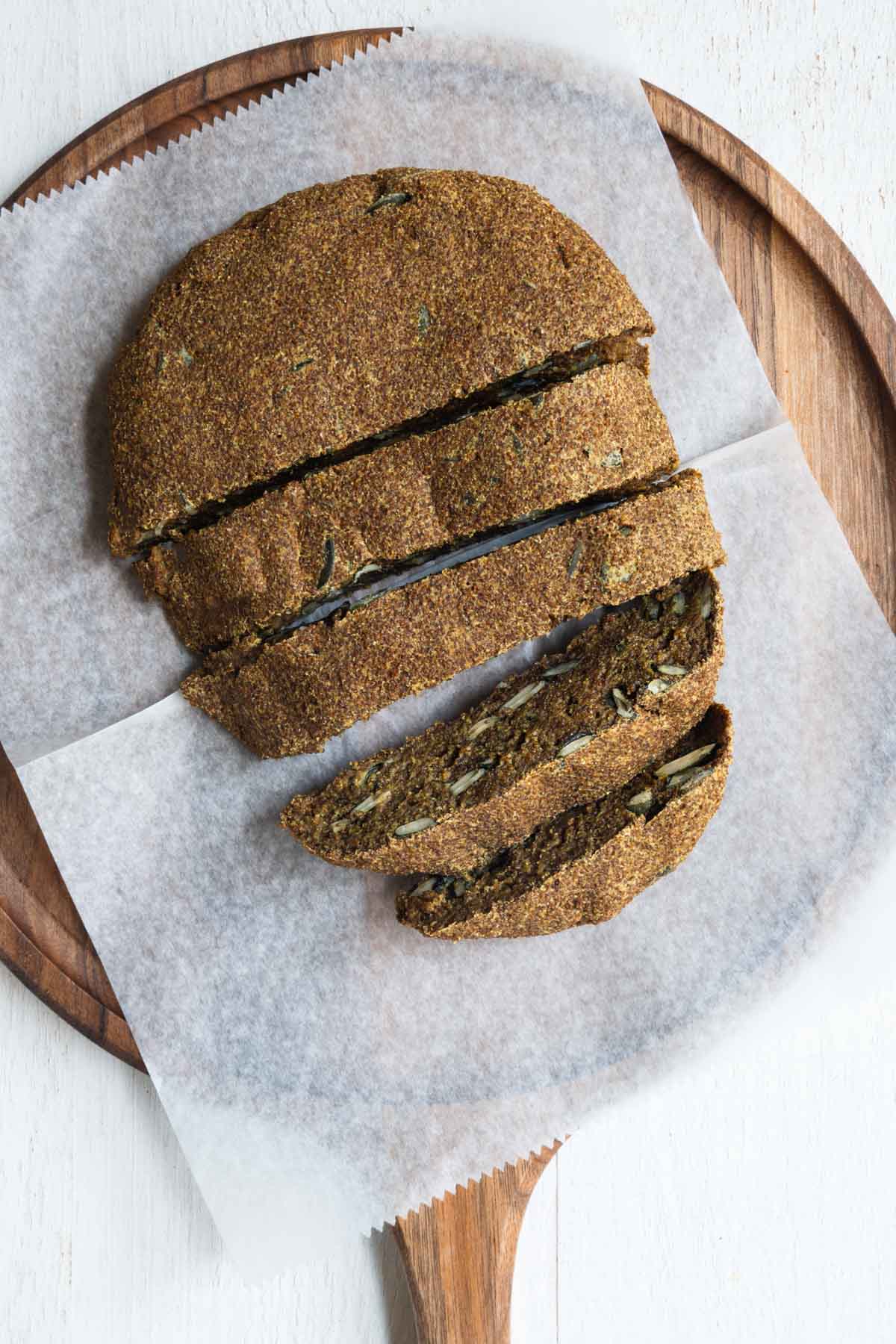 Gluten free teff bread sliced on a cutting board.