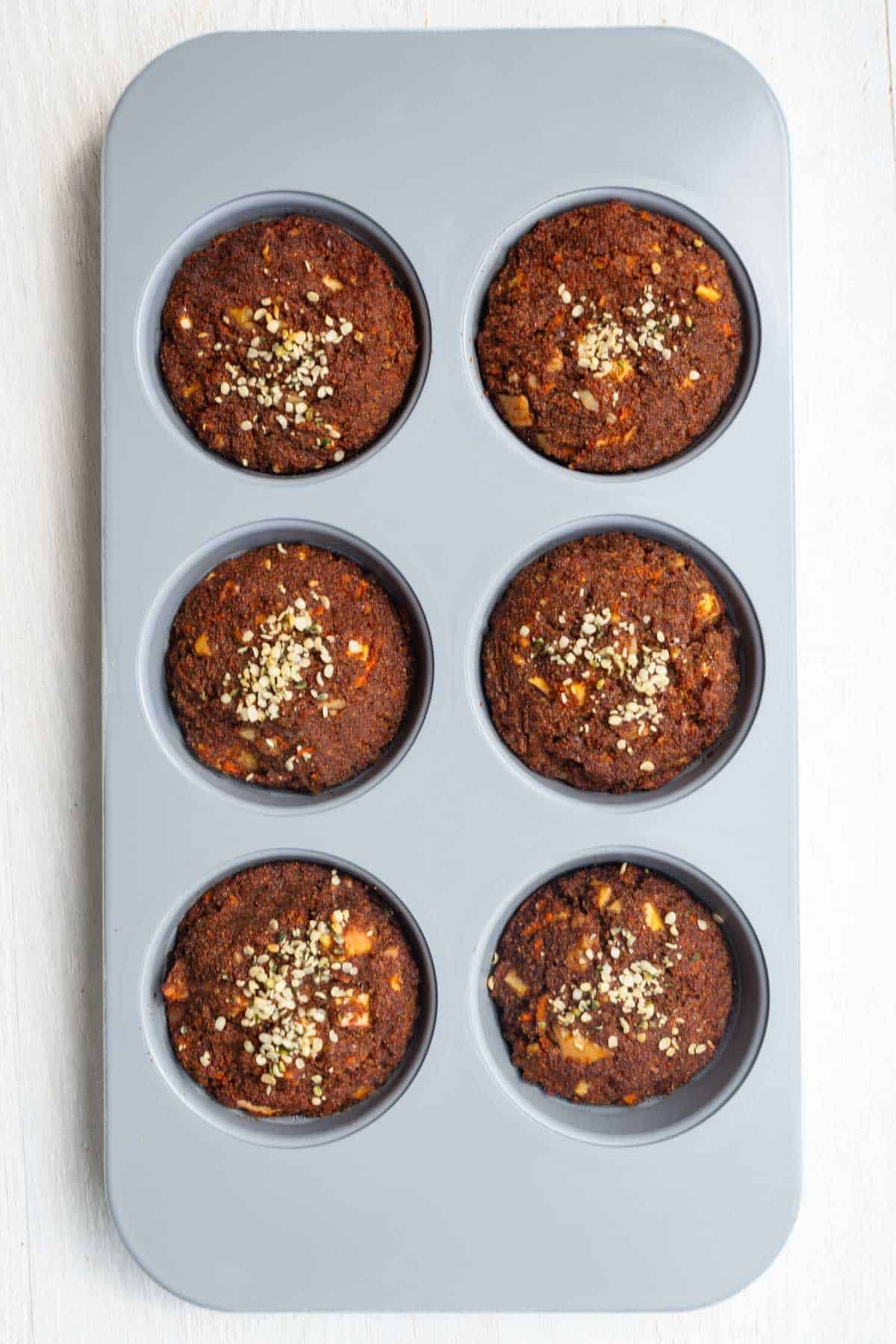 Gluten-free flourless teff breakfast muffins in a ceramic muffin tin.