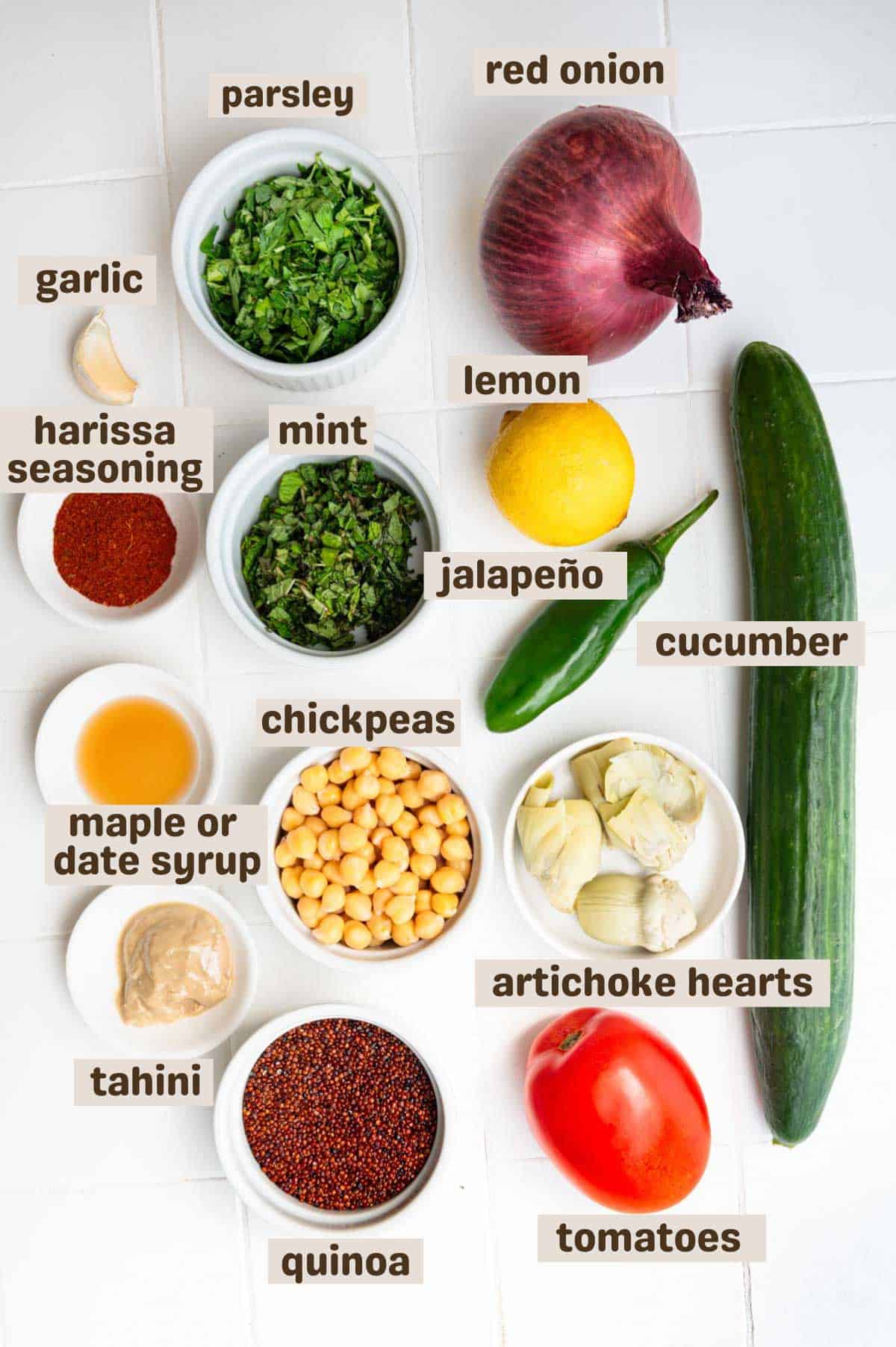 Parsley, red onion, lemon, cucumber, mint, harissa seasoning, jalapeño, tomato, quinoa, tahini, chickpeas, maple syrup, artichoke hearts, and garlic.