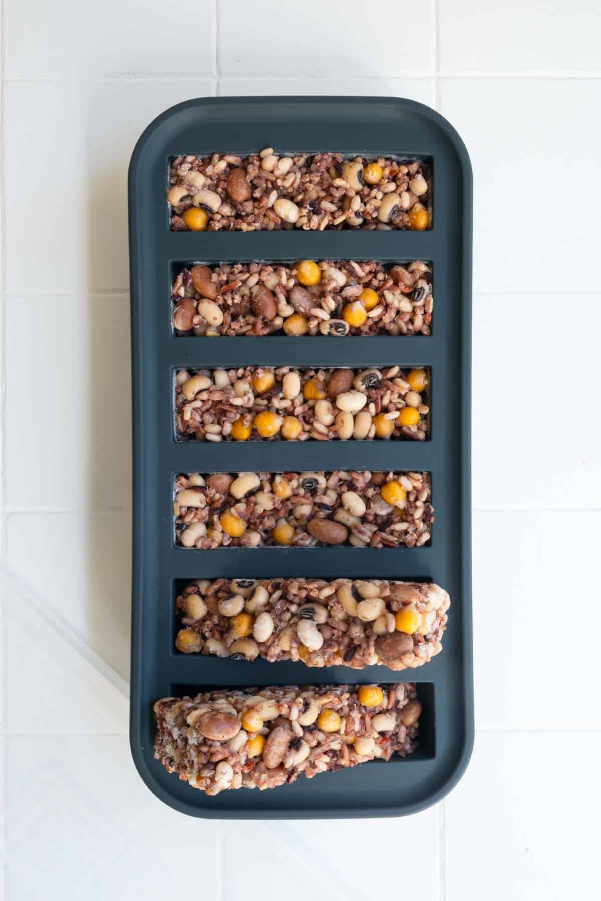 Frozen cooked rice and beans in one-half cup portions in a freezer-safe container.