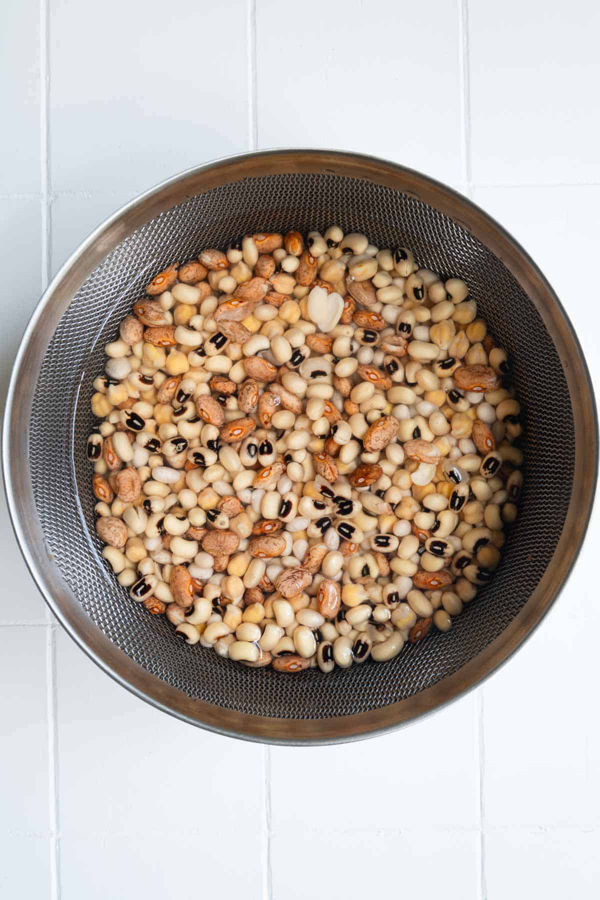 Navy beans, chickpeas, pinto beans, and black eyed peas soaking.