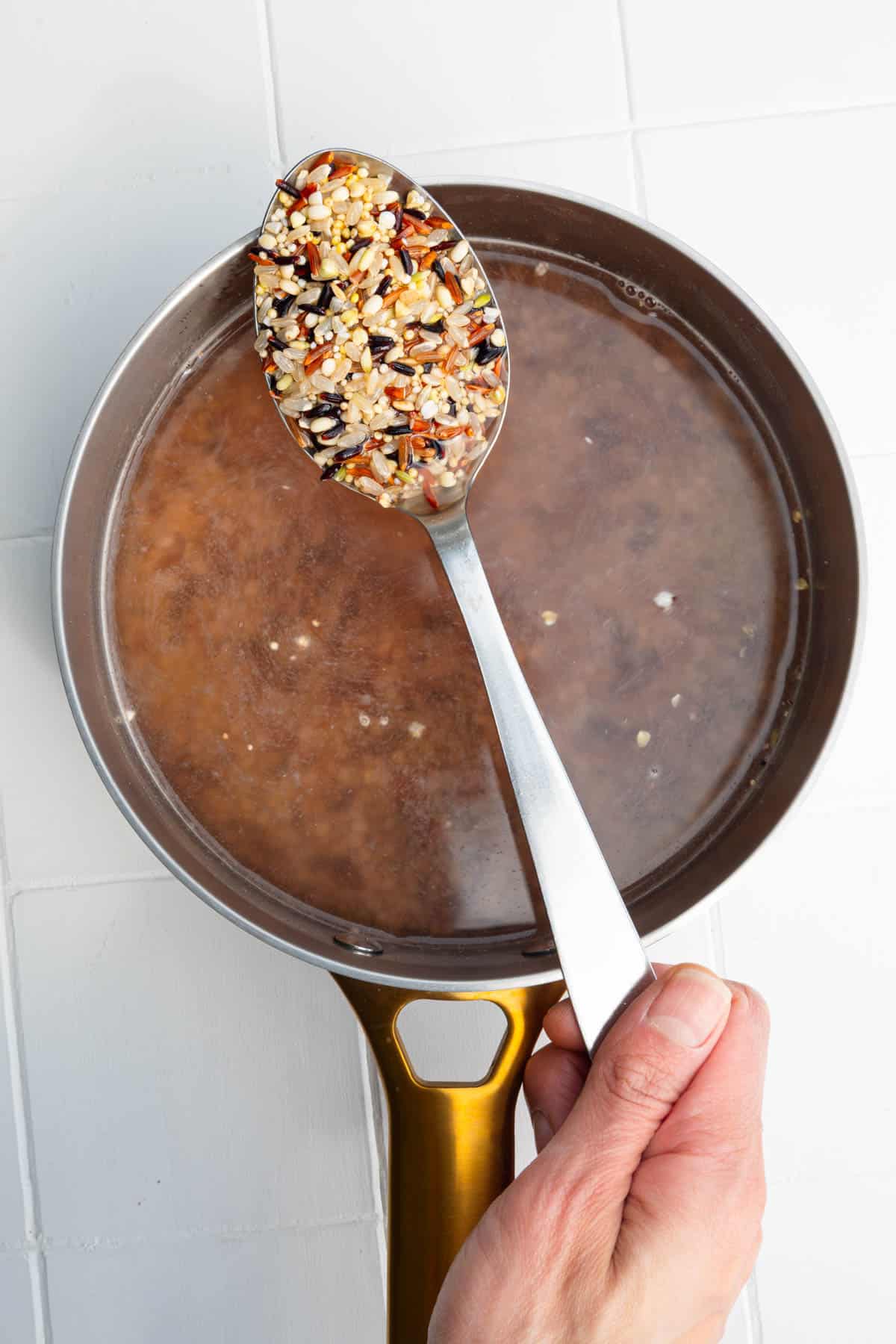 Cooking the seven grain mx with rice in a saucepan.