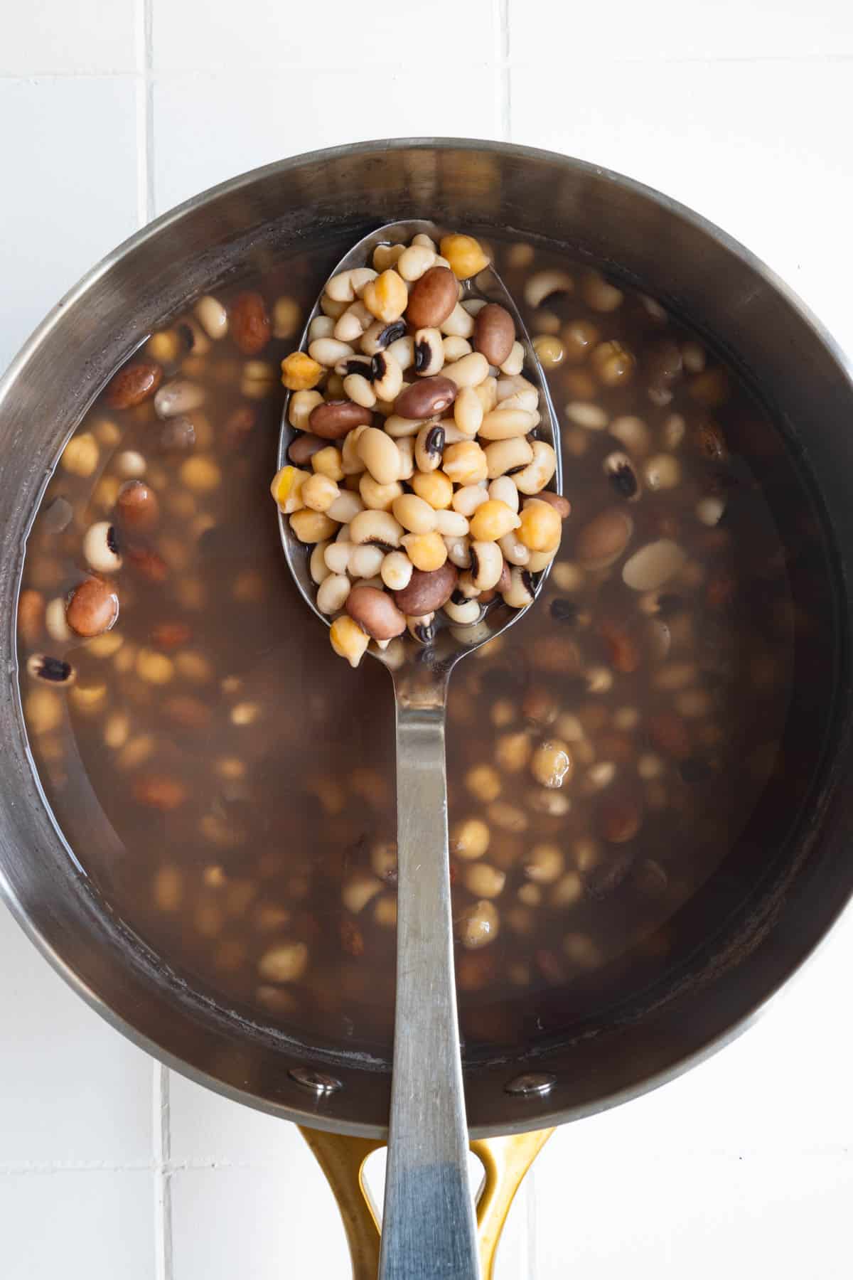Cooked beans in a saucepan.