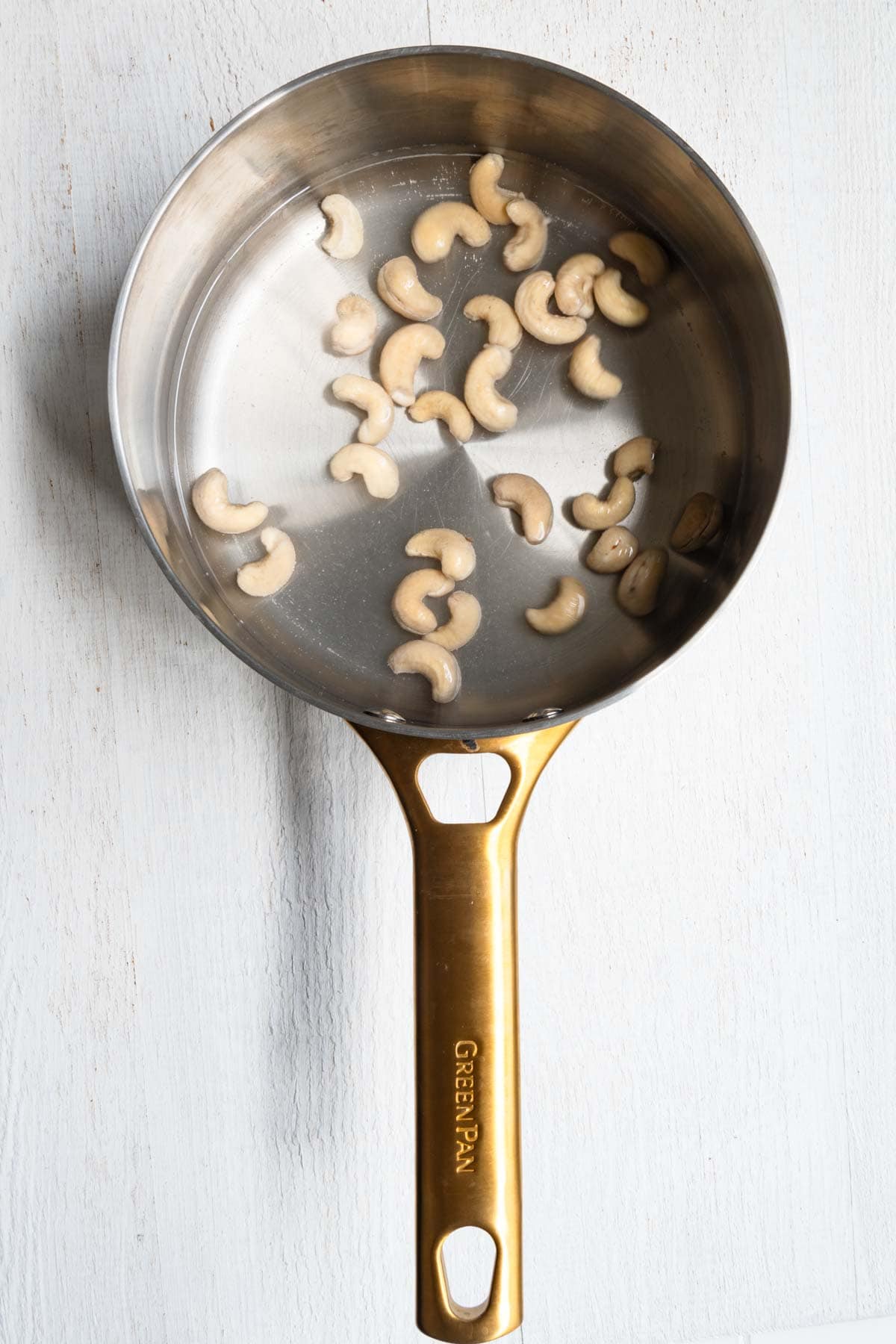 Raw cashews soaking in hot water.