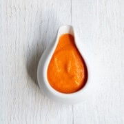 Roasted bell pepper sauce in a white container.