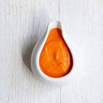 Roasted bell pepper sauce in a white container.