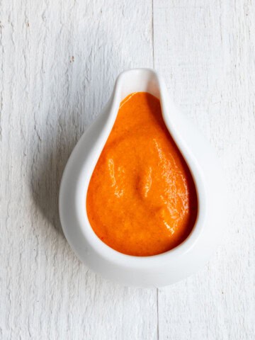 Roasted bell pepper sauce in a white container.