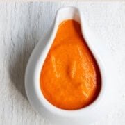 Roasted bell pepper sauce in a white container.