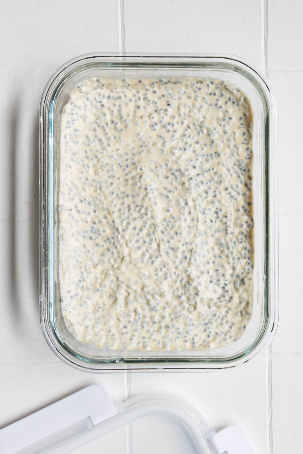 Creamy high-protein savory chia pudding in a glass meal-prep container.