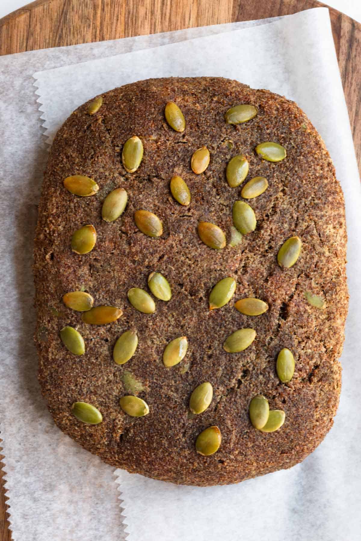Teff Bread topped with pumpkin seeds.