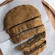 Gluten-free teff bread sliced on a cutting board.