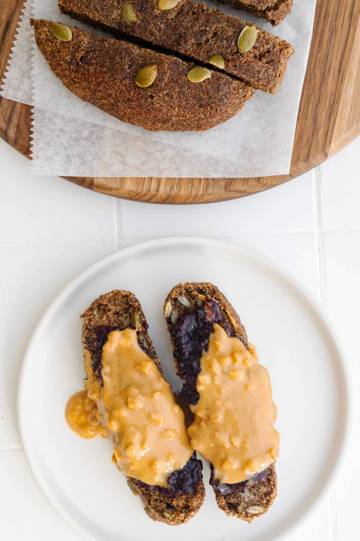 Teff bread sliced and topped with peanut butter and chia jam.