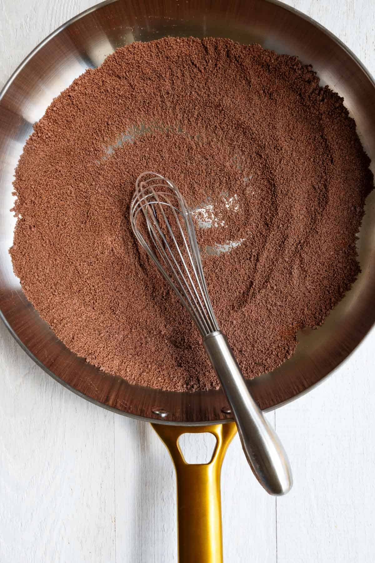 Toasted teff whisked with cocoa powder, cinnamon, and cayenne in a large skillet.
